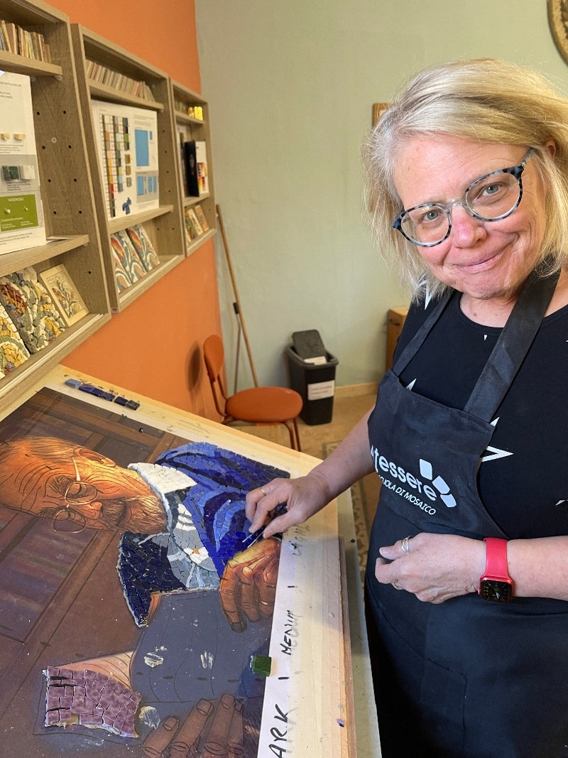 An American student attending the professional mosaic course of In Tessere in Narni Italy while creating a contemporary colorful mosaic