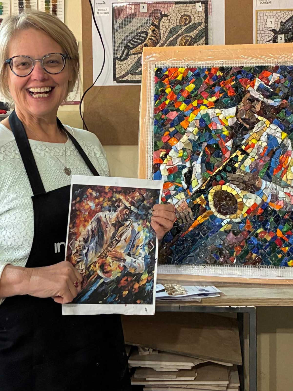 A smiling student from the professional mosaico course in Italy of the In Tessere Mosaic School